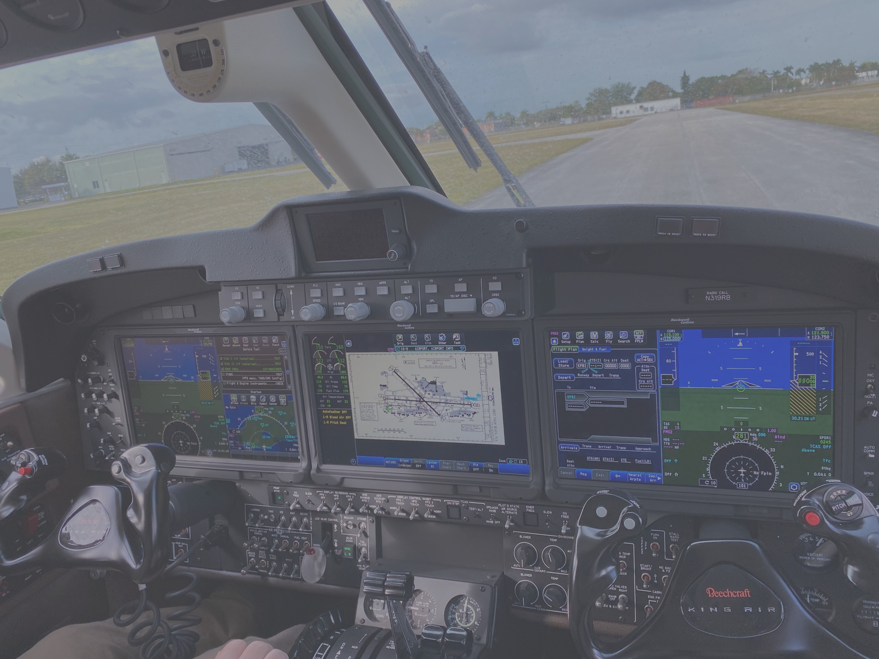 Michael Leighton at the controls of a King Air, glass cockpit panel on the runway
